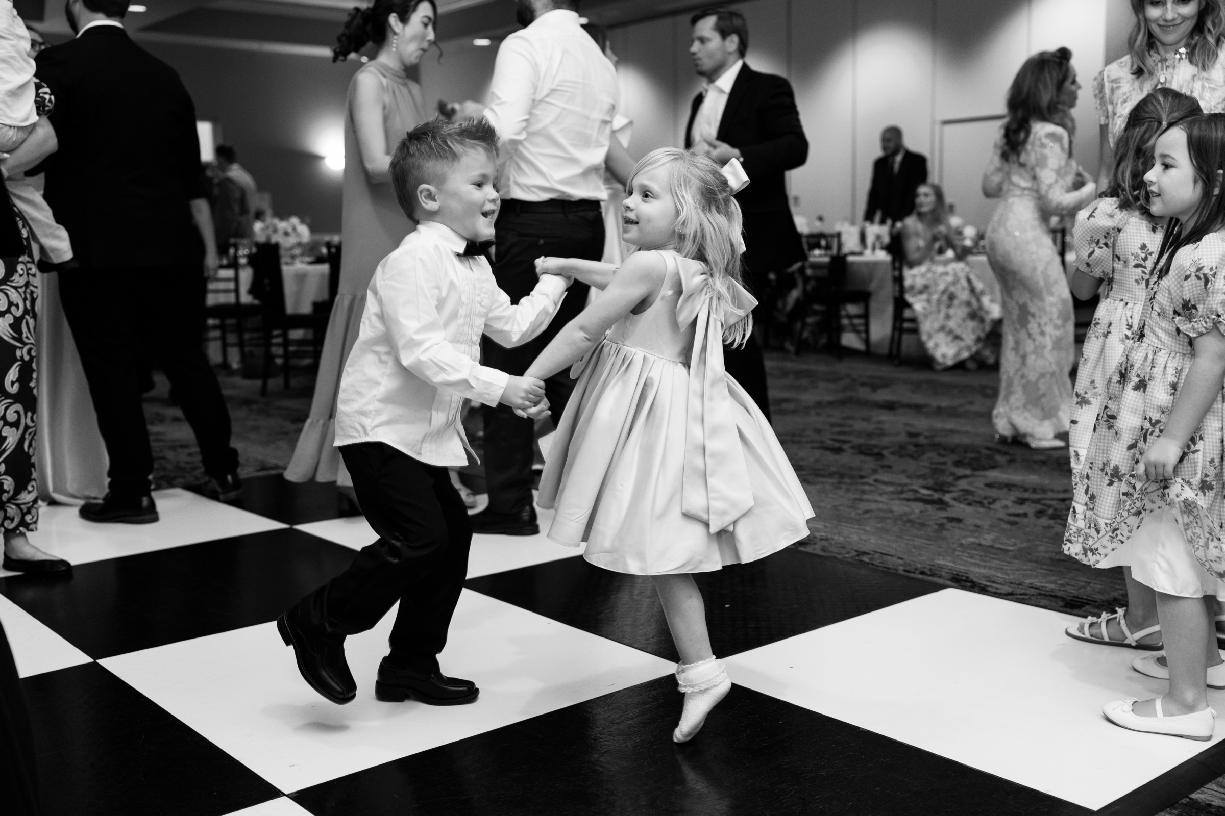 black and white picture of wedding guests dancing