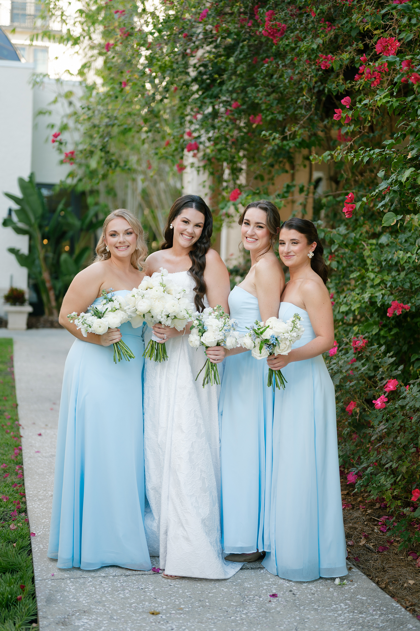 bride with bridesmaids wearing baby blue dresses
