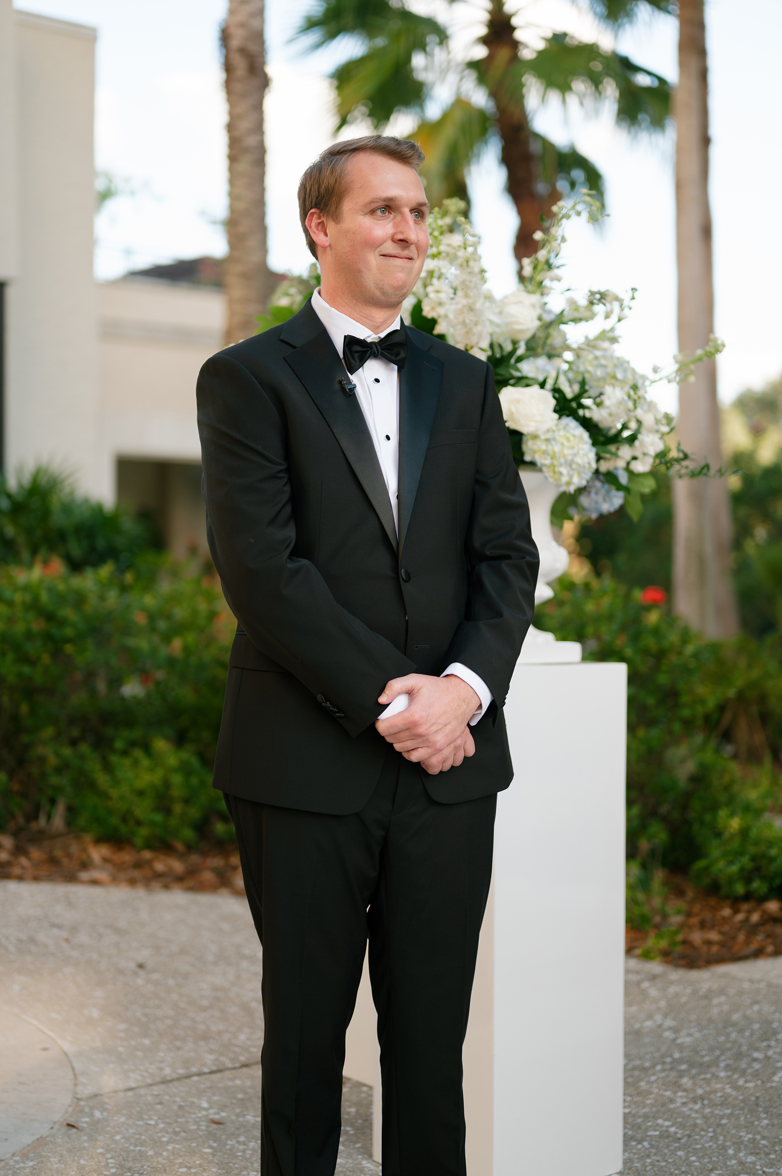 groom watching bride walk down the aisle