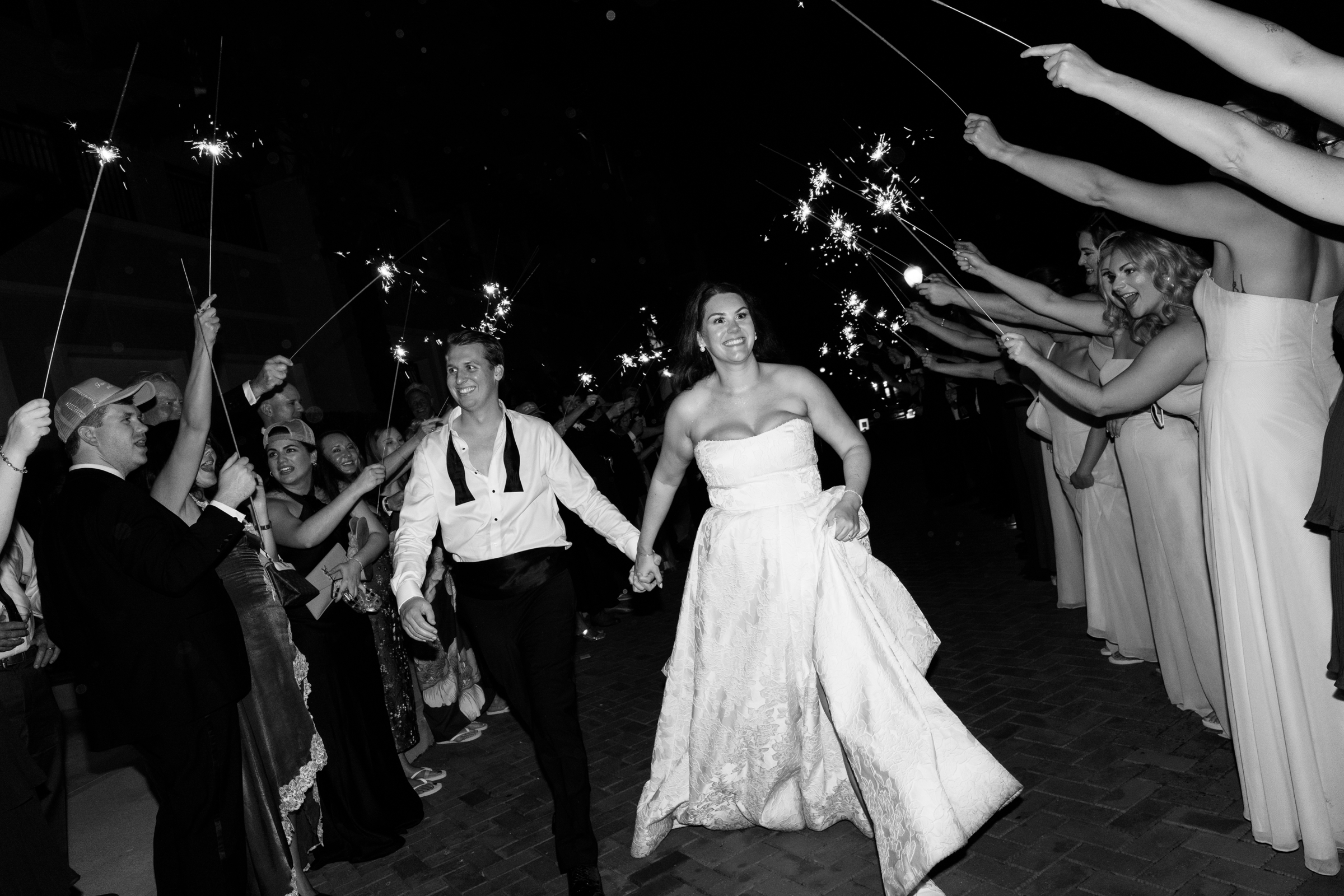bride and groom exiting wedding reception