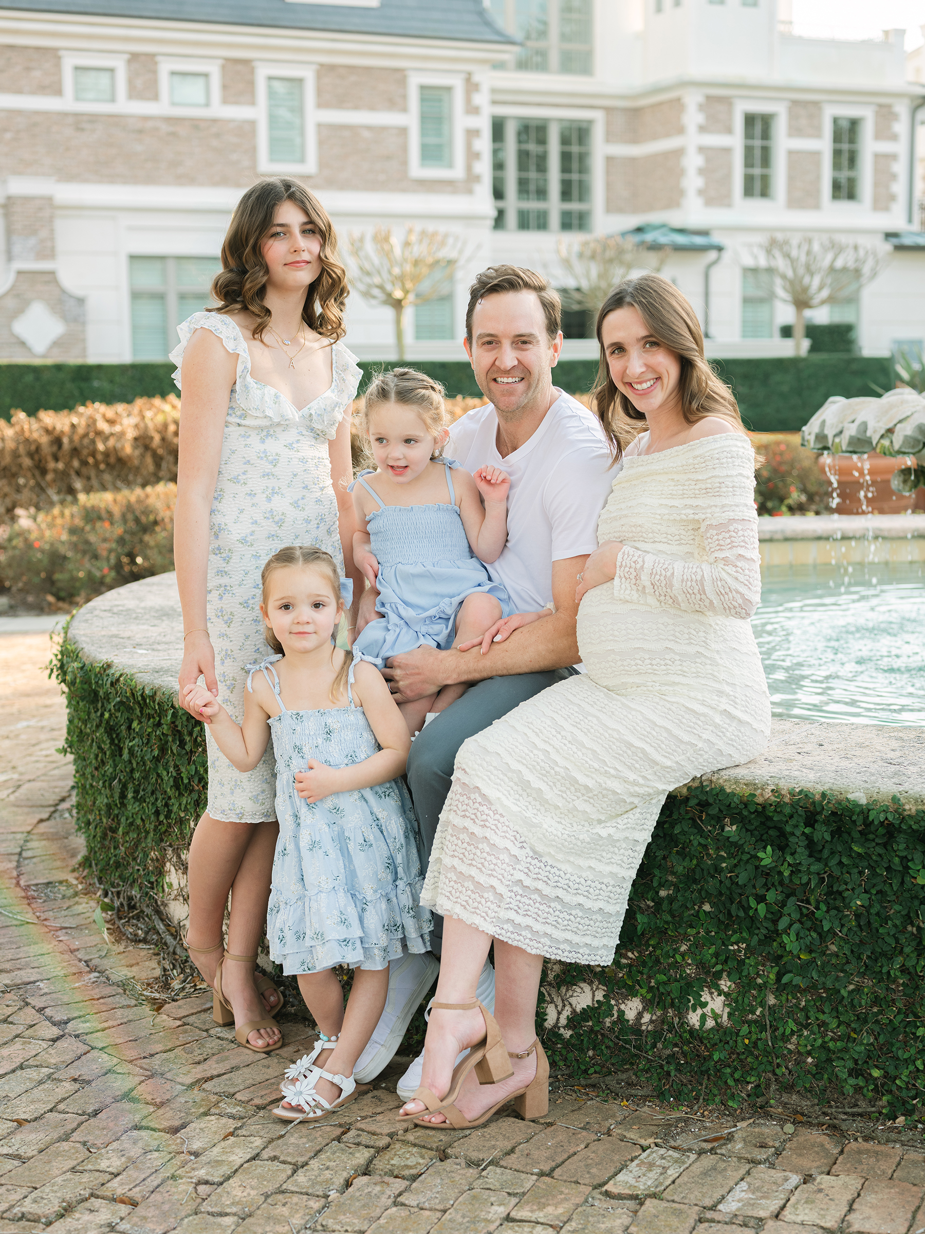 maternity family portrait in front of water fountain