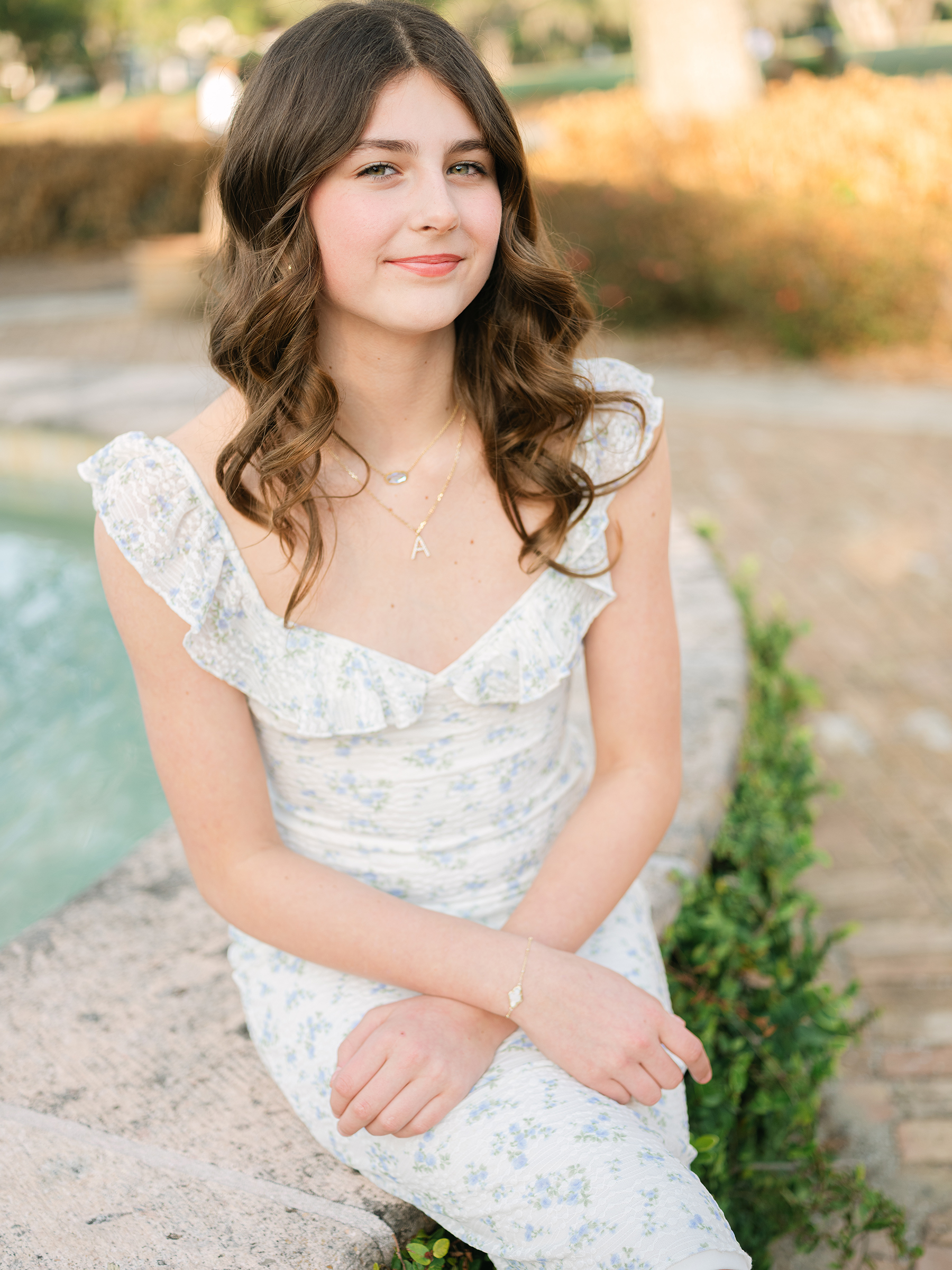 portrait of girl wearing white dress with blue florals