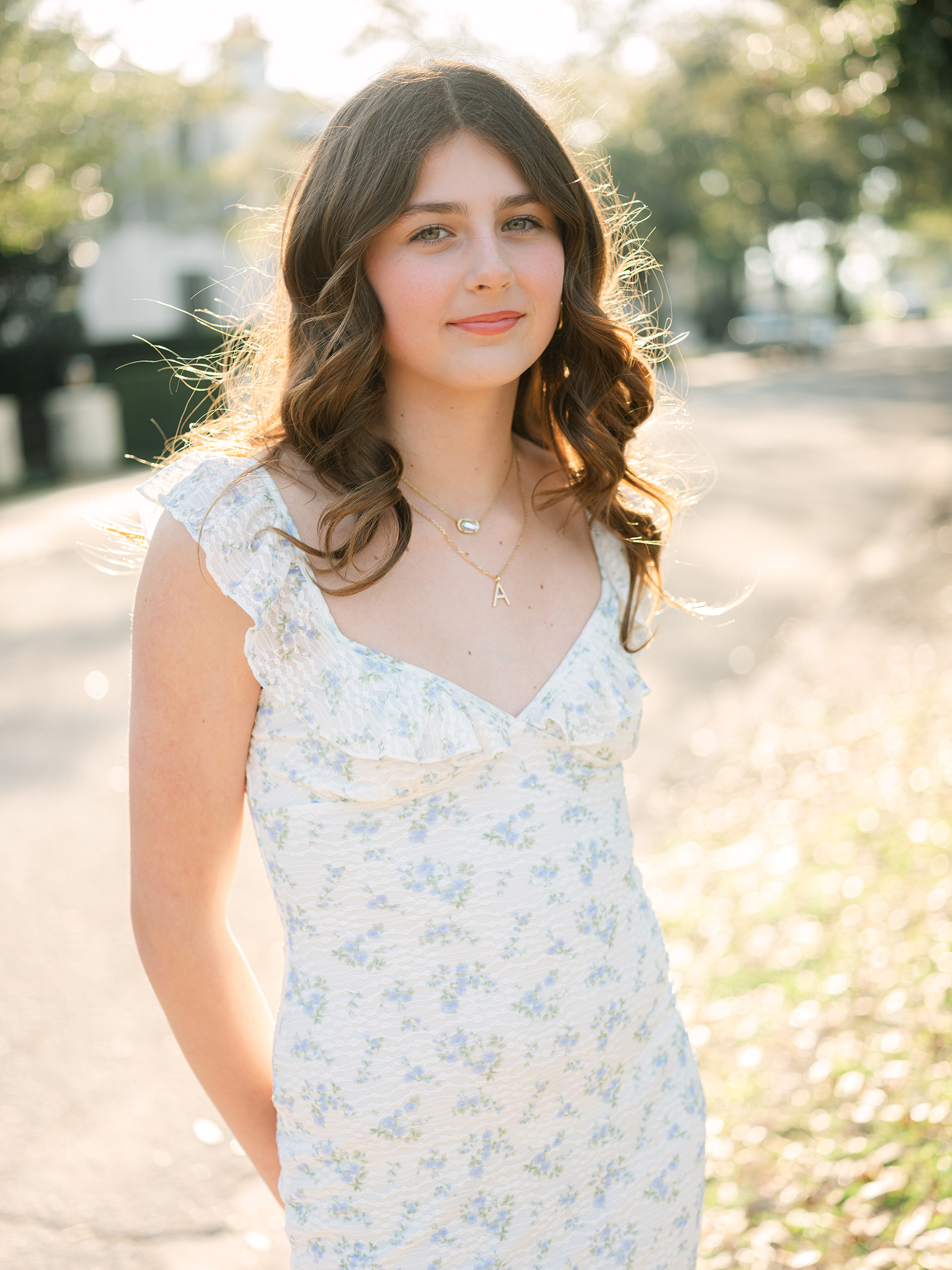 portrait of girl wearing white dress with blue florals