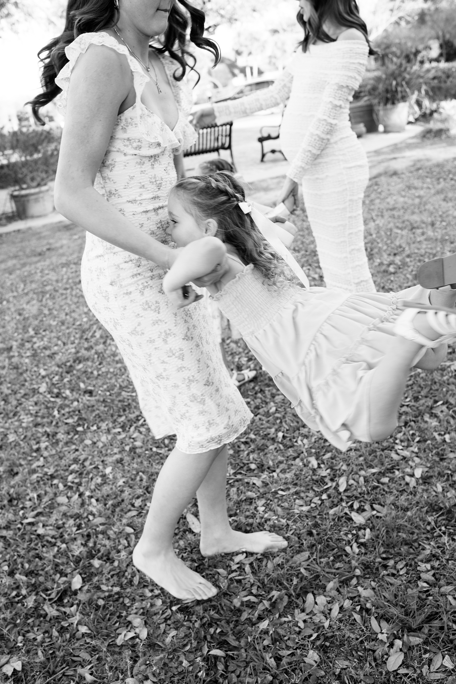 little girl getting twirled in the air