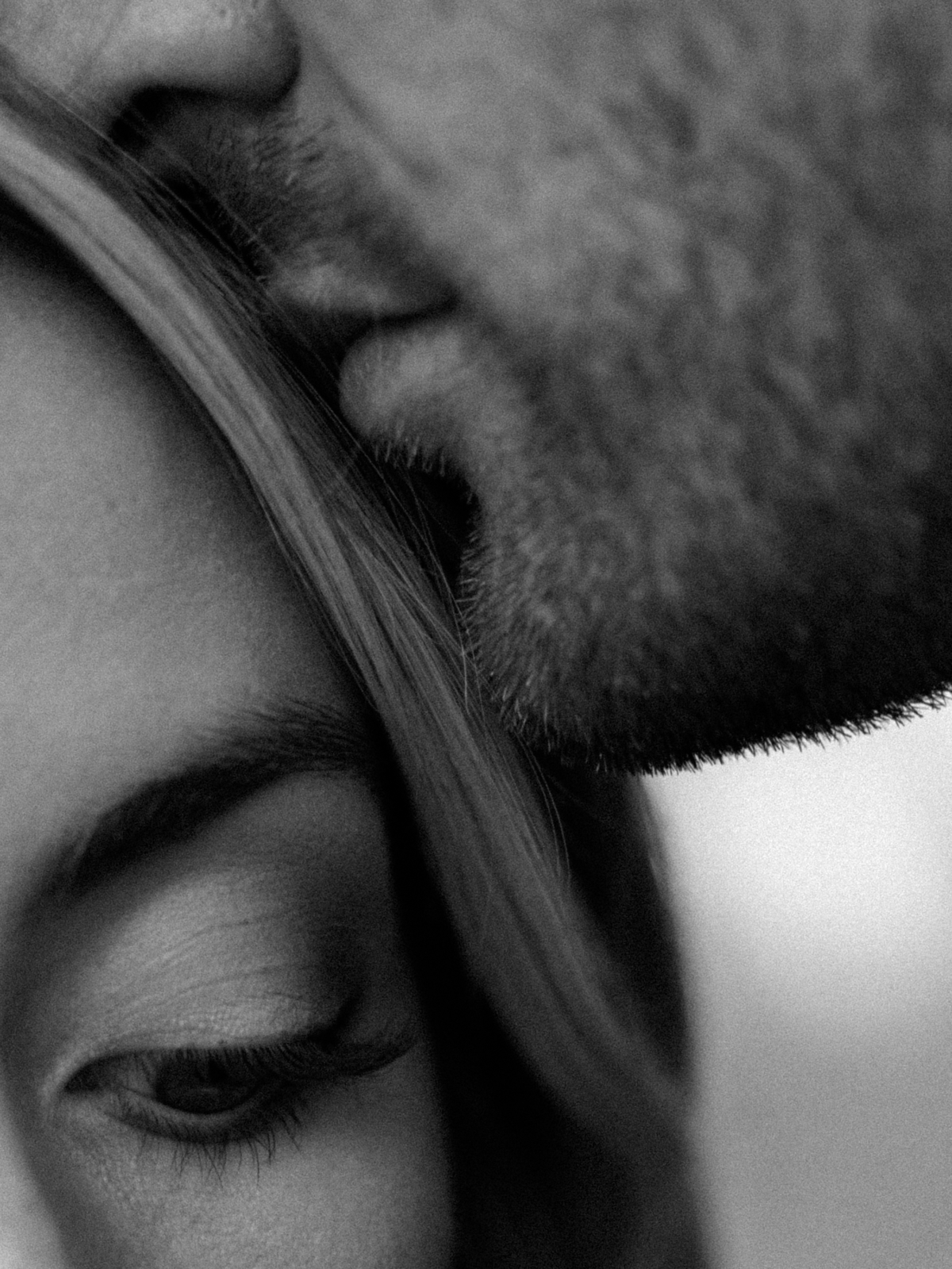 Black and white editorial close-up of Joao kissing Lauren's forehead.